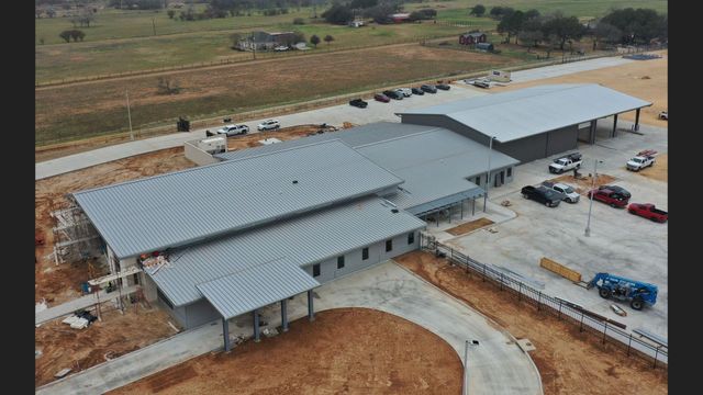 Aerial view of a newly installed standing-seam metal roof on a commercial building
